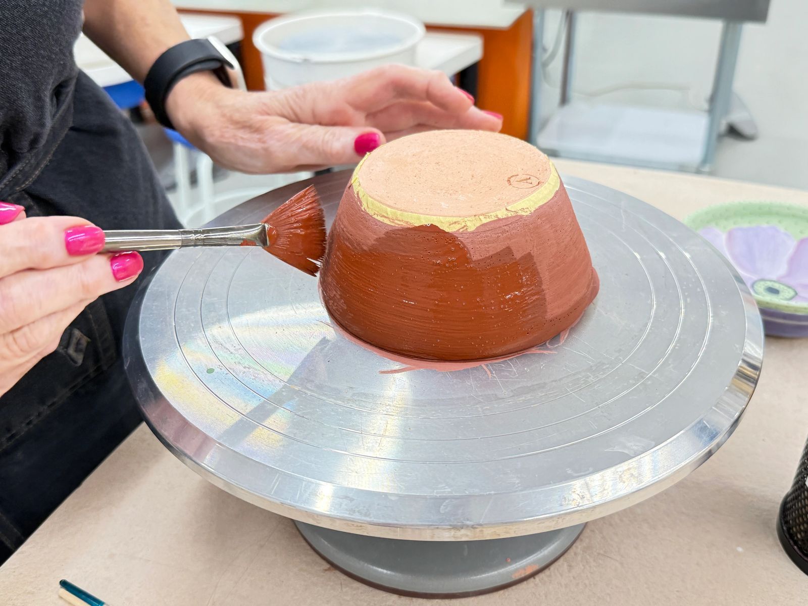 Close-up of trimming a bowl on the pottery wheel